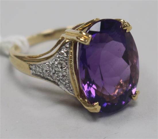 A modern 9ct gold, amethyst dress ring with diamond set shoulders, size N.